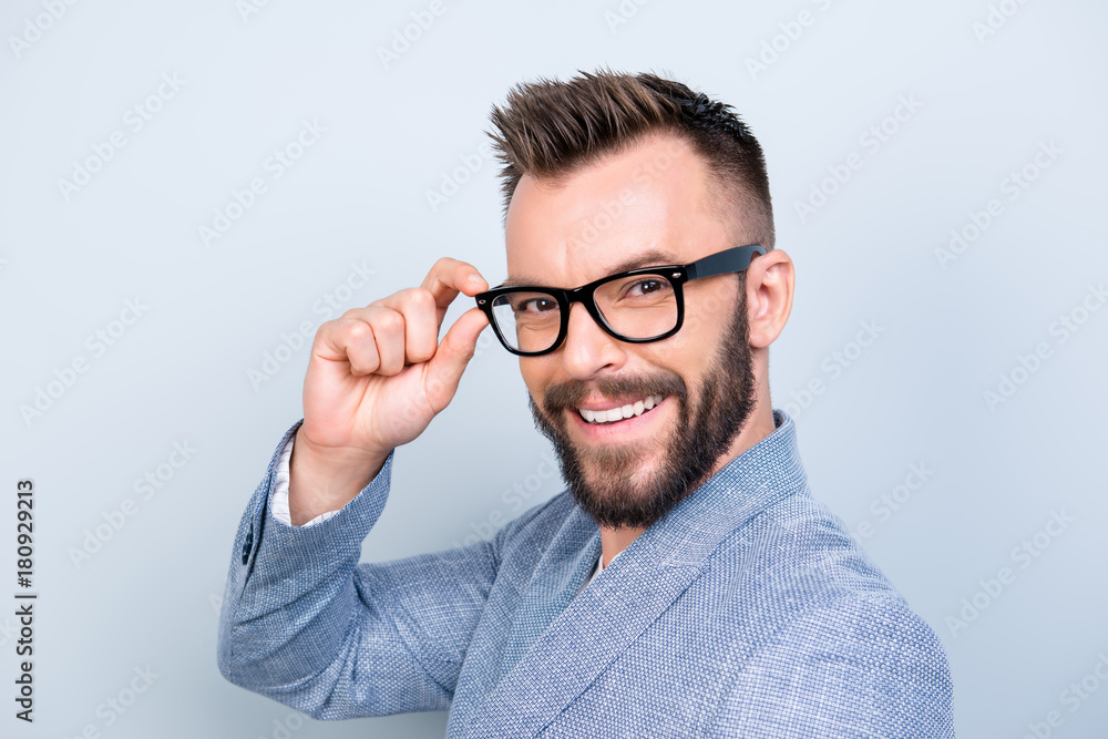 Φωτογραφία Close up of successful young handsome brunet bearded businessman in formal outfit and black glasses on pure background