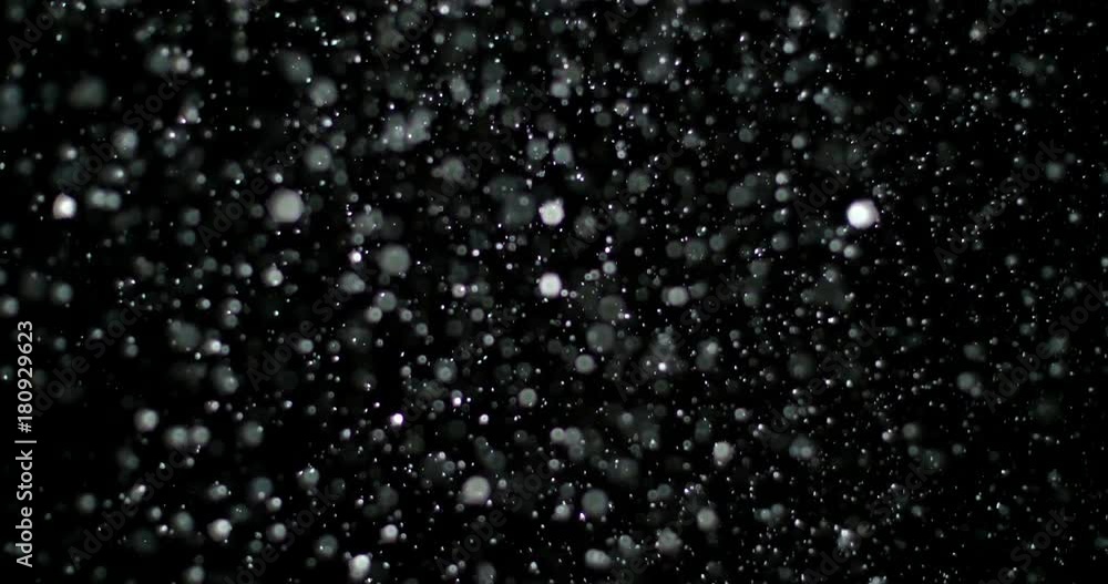 Slow Motion Snowfall Bokeh Lights on Black Background, Shot of Flying Snowflakes in the Air Slow Motion Snowfall Bokeh Lights on Black Background, Shot of Flying Snowflakes in the Air