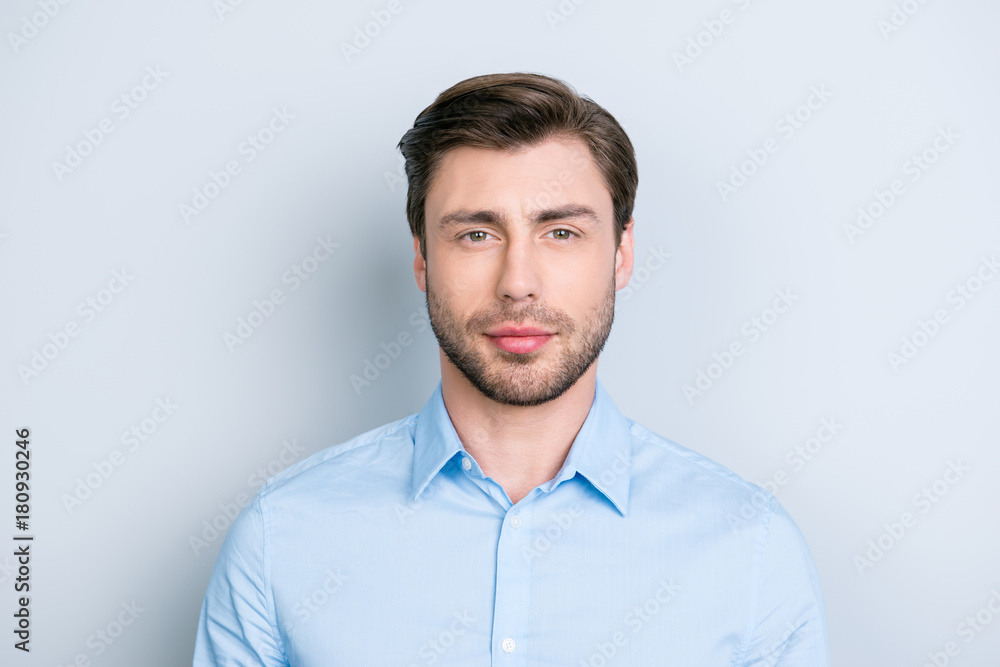 close up portrait of successful brunet man looking at camera with kind and a little bit tricky glance while standing over grey background close up portrait of successful brunet man looking at camera with kind and a little bit tricky glance while standing over grey background