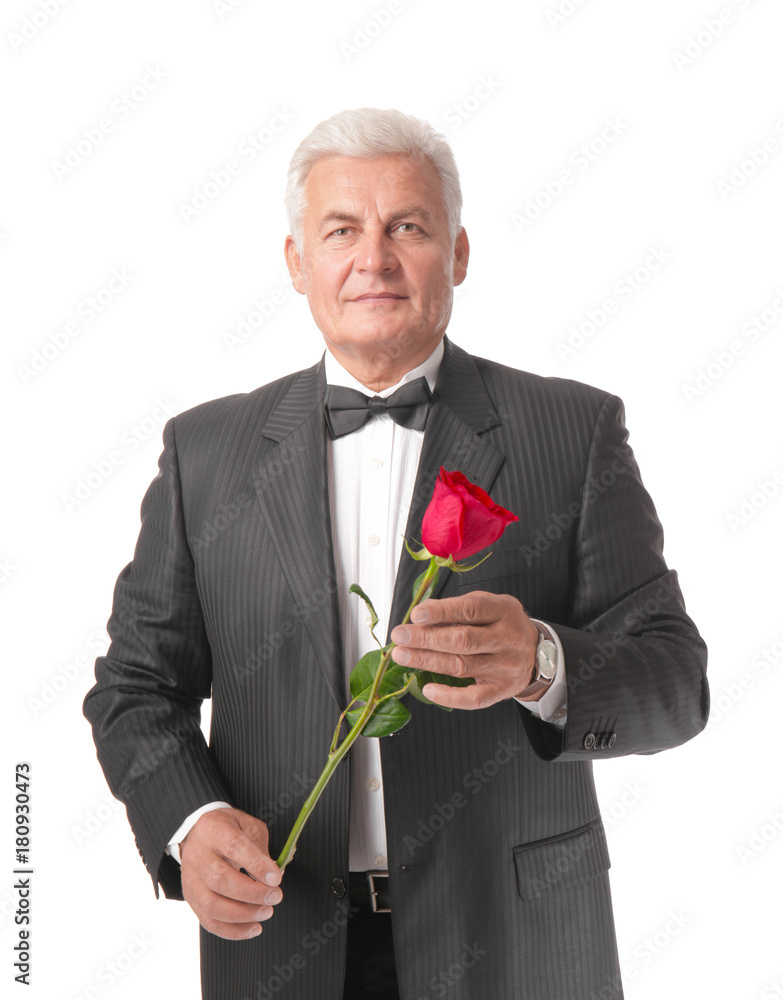 Handsome mature man in suit holding red rose, isolated on white Handsome mature man in suit holding red rose, isolated on white