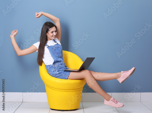 Young woman with laptop in ...