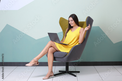 Young woman with laptop in ...