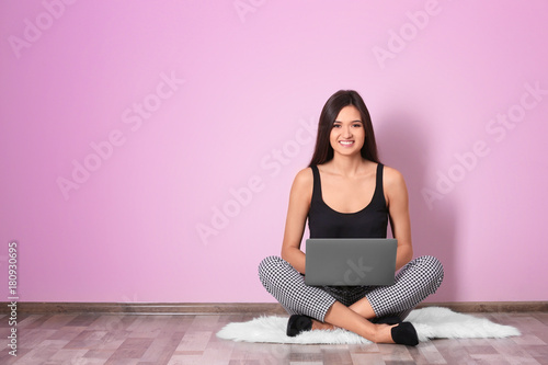 Young woman with laptop on ...