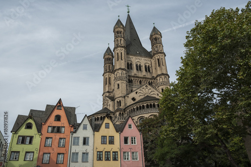 COLOGNE, GERMANY - SEPTEMBER 11, 2016: Colorful houses in Bavarian style and the Romanesque Catholic church "Gross Sankt Martin" (Great St. Martin) in the old town of Cologne, North Rhine-Westphalia