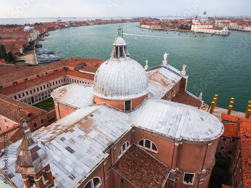 Looking down on the domed rooftop of San Giorgio Maggiore with Doges Palace and San Marcos Square in the background