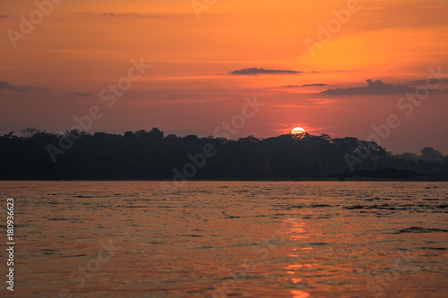 Manu National Park, Peru - August 09, 2017: Sunrise in the Amazon rainforest of Manu National Park, Peru photo