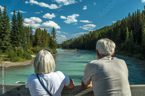 Elderly couple looking to a beatiful river