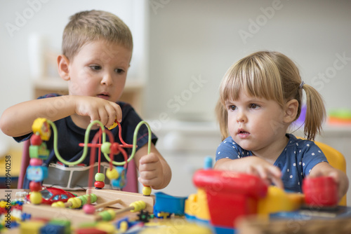 Brother and sister is playing at pre school