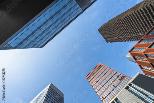 Perspective and directly below view of modern highrise.