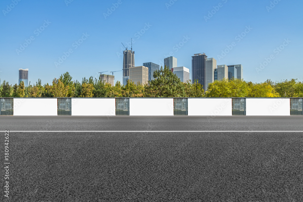 empty asphalt road and blank billboards front of modern buildings. empty asphalt road and blank billboards front of modern buildings.
