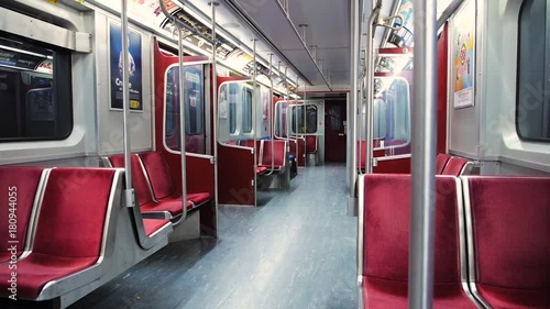 Wide shot of riding an empty subway car late at night photo