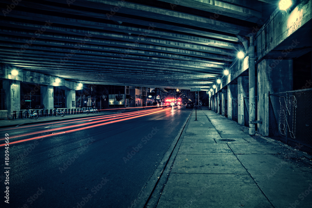 Fire trucks, ambulance, police and traffic in a dark Chicago tunnel viaduct street at night.