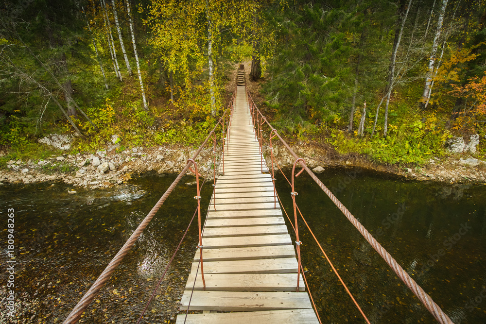Obraz premium Wooden bridge above the river