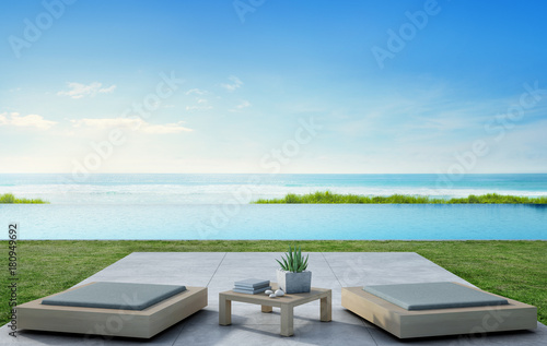 Sea view swimming pool beside terrace and modern furniture in luxury beach house with blue sky background, Lounge for outdoor living at vacation home or hotel - 3d illustration of tourist resort