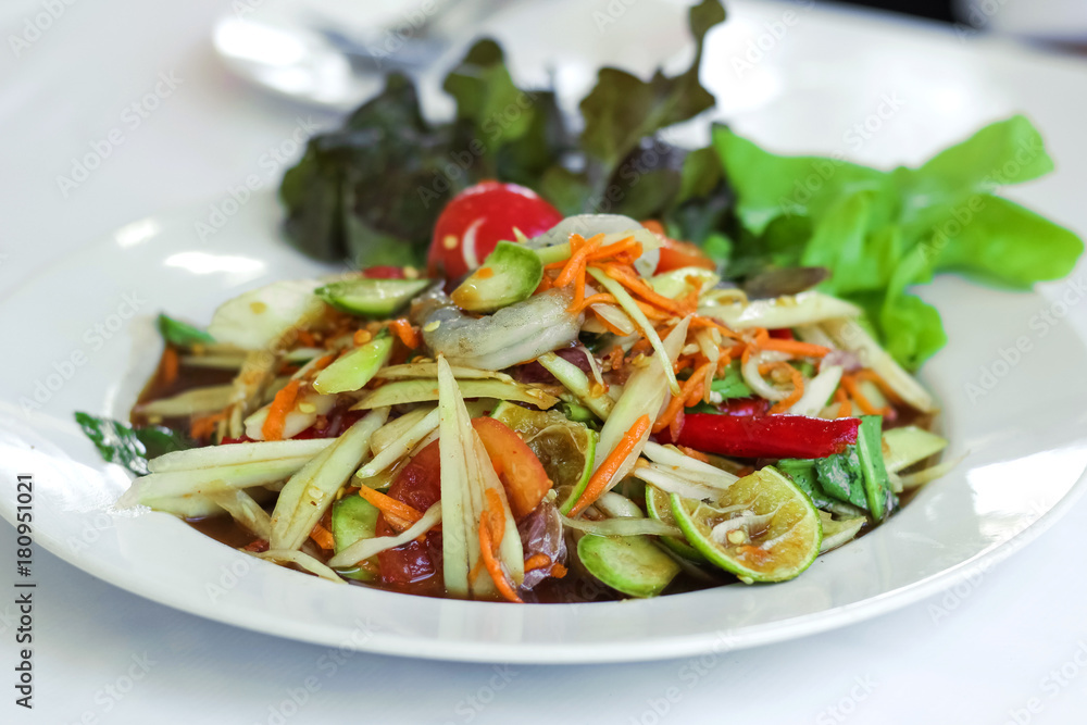 Fresh papaya salad with shrimp and carrot garnish with salad leaf Fresh papaya salad with shrimp and carrot garnish with salad leaf
