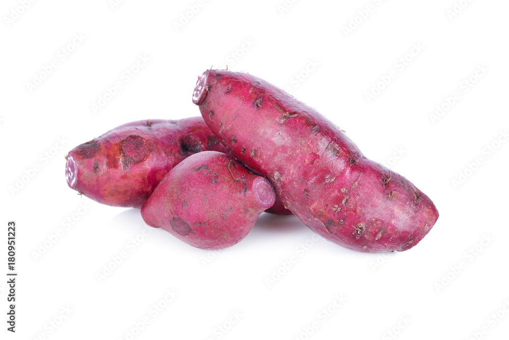 unpeeled raw purple potato on white background unpeeled raw purple potato on white background