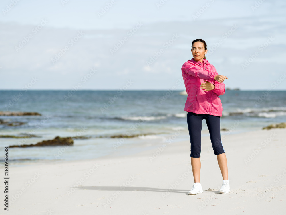 Young woman at the beach doing exercises