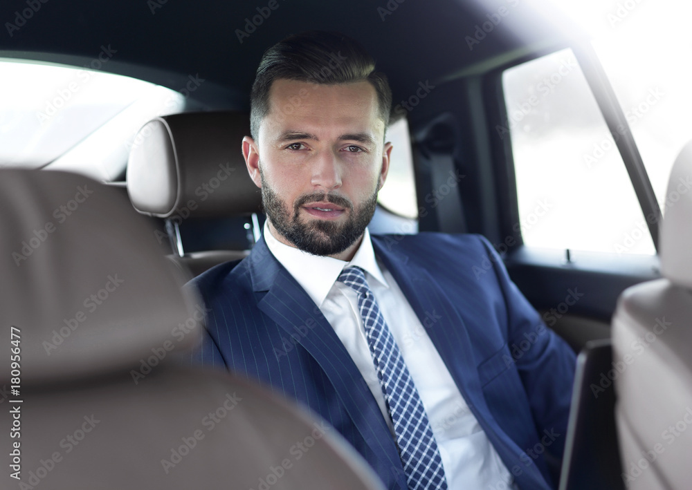 Close-up of a successful businessman sitting in a car Close-up of a successful businessman sitting in a car