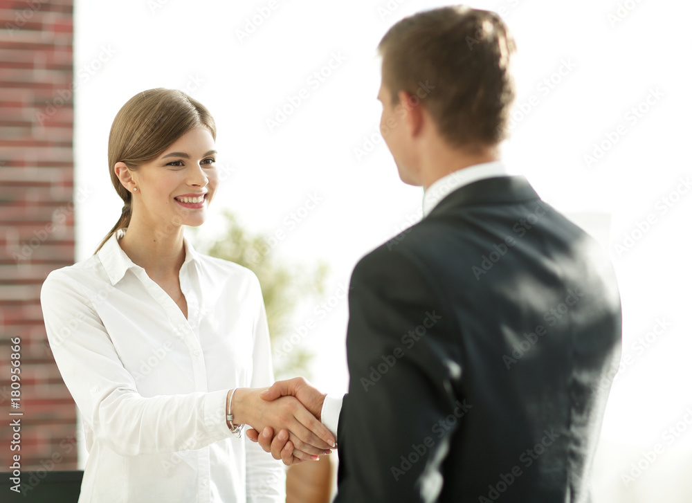 handshake young business woman with a colleague handshake young business woman with a colleague