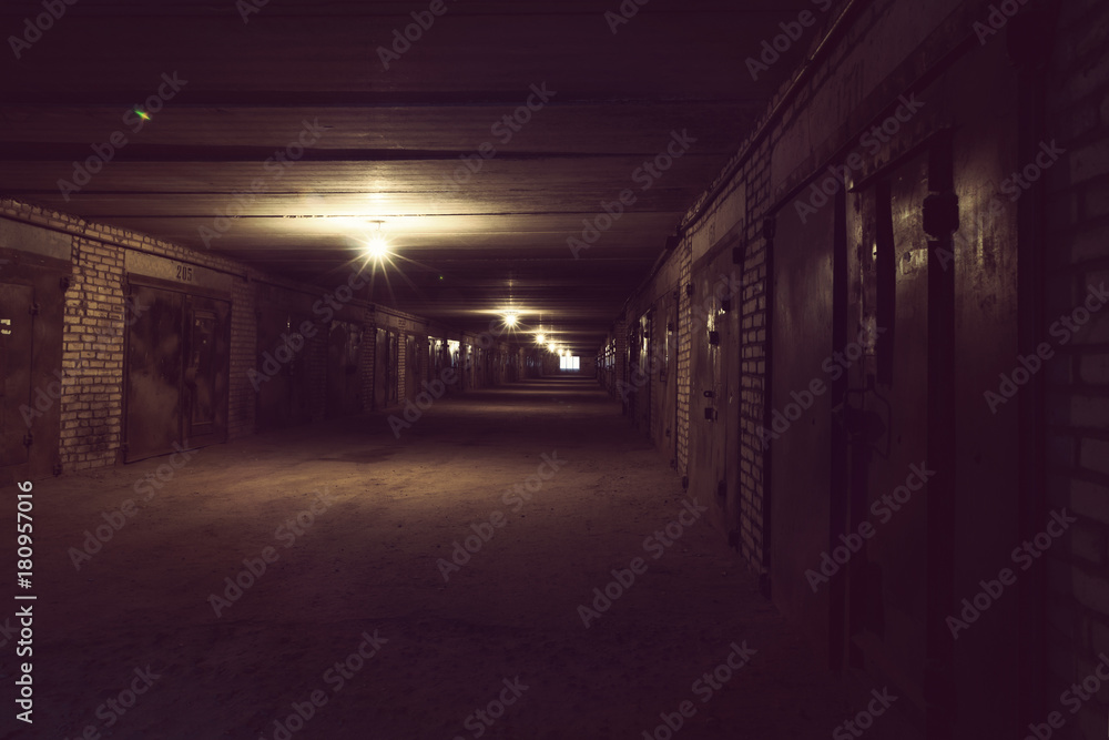 Dark long hallway with metal gates and working bulbs Dark long hallway with metal gates and working bulbs