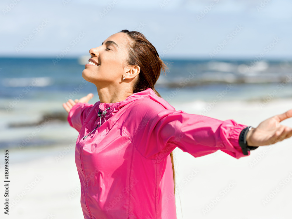 Athletic woman in sportswear standing at the seaside Athletic woman in sportswear standing at the seaside