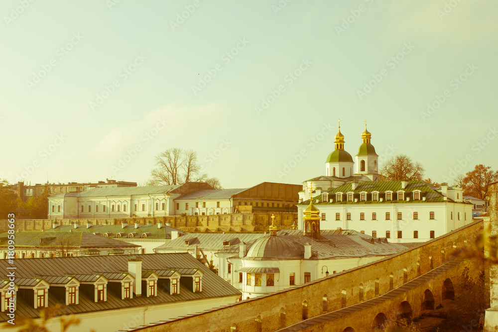 Panoramic view of distant and near caves of the ancient Christian monastery in Kiev, Ukraine. Kiev-Pechersk Lavra. Color toning. Old photo.