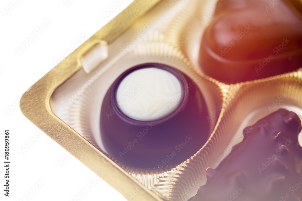 Obraz premium A collection of mixed chocolates against a white background