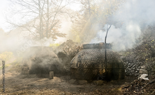 The production of charcoal in a traditional manner in the forest photo