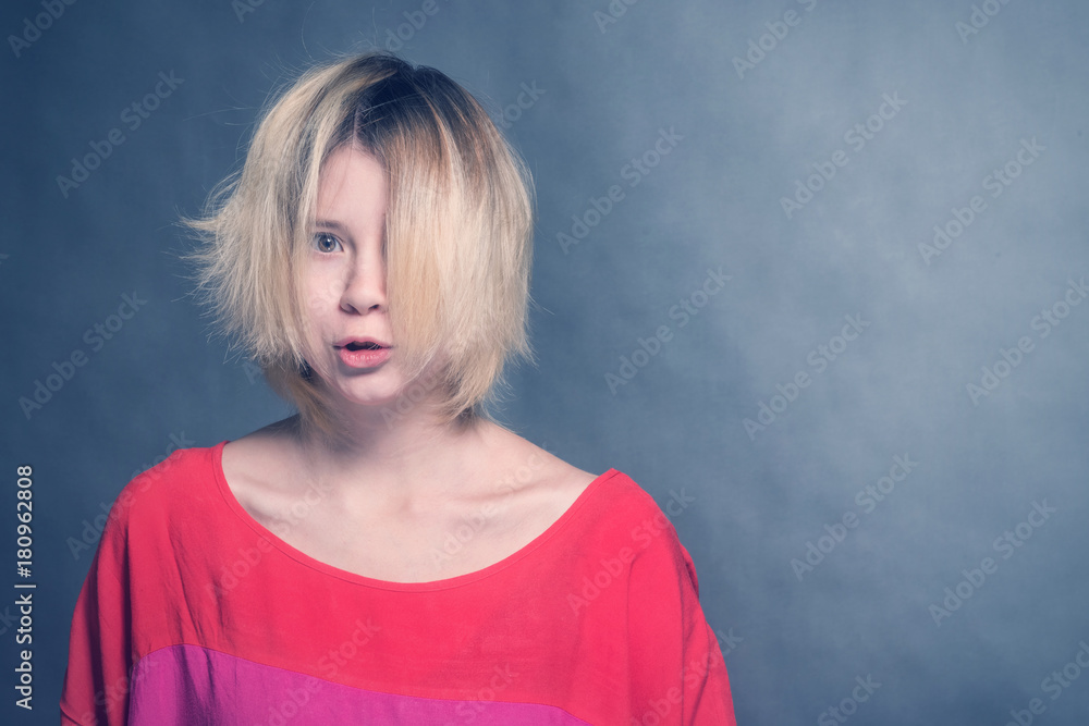 Sad blonde girl teenager in a red blouse Sad blonde girl teenager in a red blouse