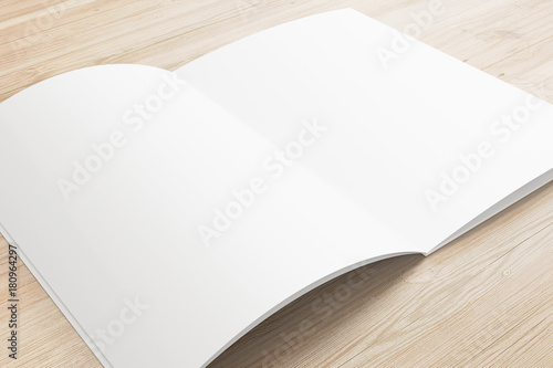 Opened magazine or brochure on wooden background.