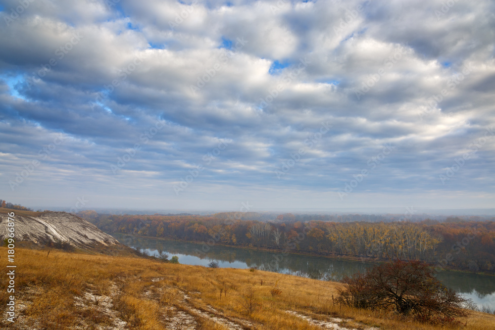 Autumn landscape. Cretaceous hills of the Don River. View on the pond on a background of cloudy sky.