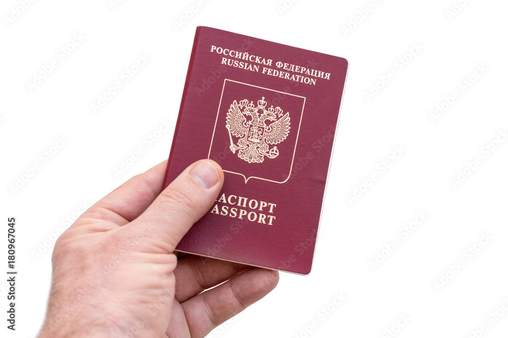 Russian passport in the man's hand on a white background. Isolated Russian passport in the man's hand on a white background. Isolated