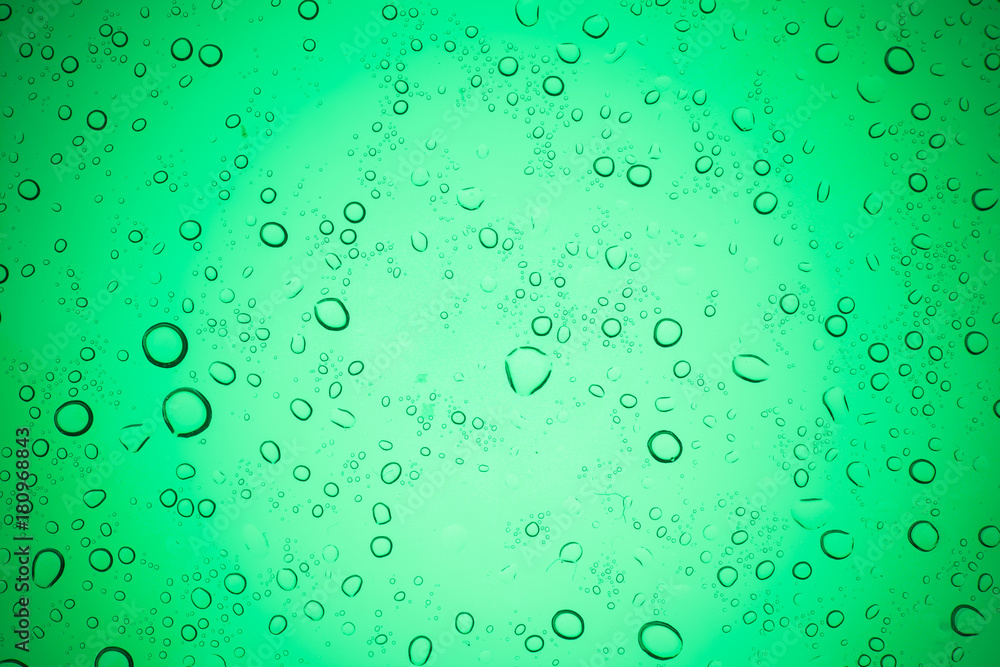Rain droplets on green glass background, Water drops on glass.