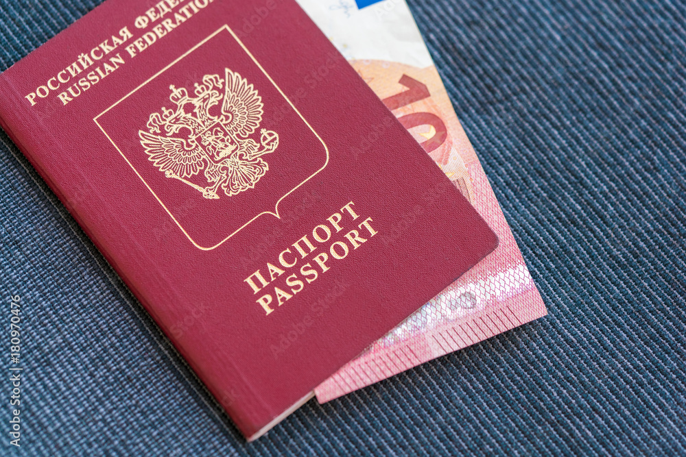 10 euros in the Russian passport on a blue textile background 10 euros in the Russian passport on a blue textile background