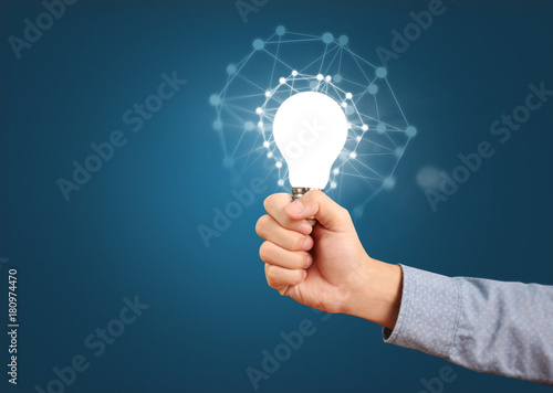 Wallpaper Mural holding lightbulb in  hand Torontodigital.ca