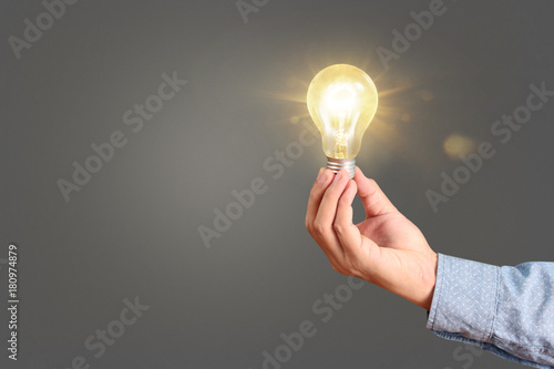 holding lightbulb in hand