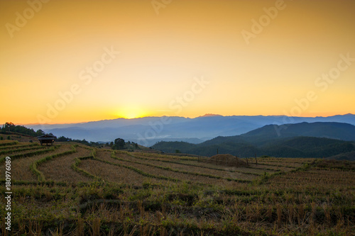 Fototapeta Naklejka Na Ścianę i Meble -   Thai village surrounded by forests and plowed fields at sunset. Agriculture in Thailand, arable land and pastures.