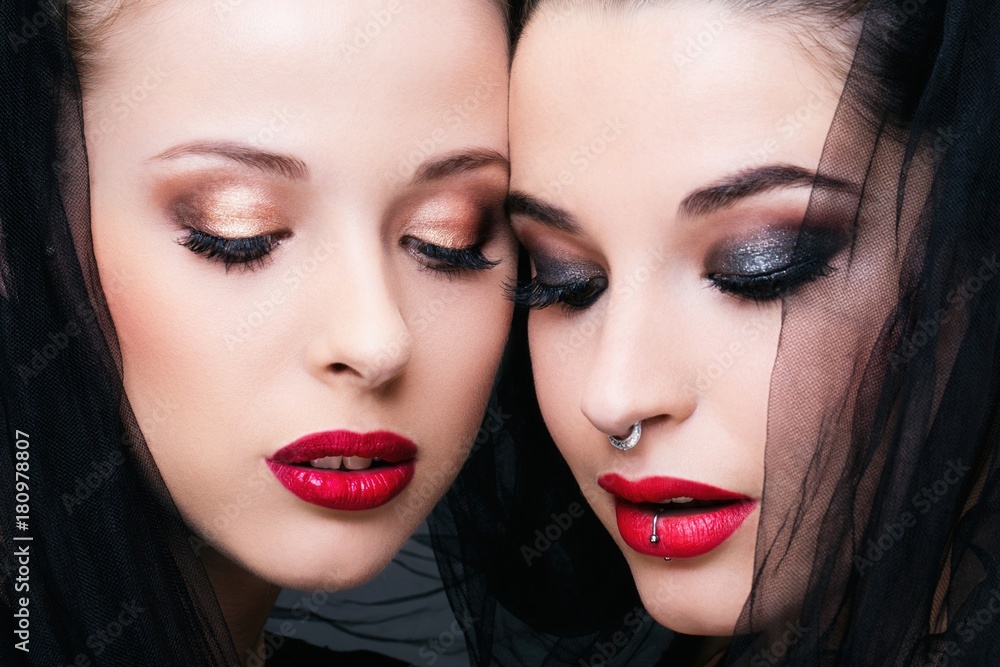 Close up of two young women in profile, looking down Close up of two young women in profile, looking down
