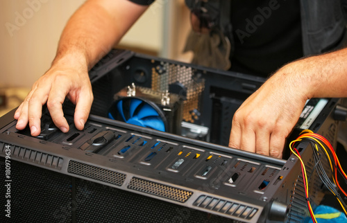Computer technician installs system of computer. Assembling PC