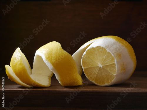 Cut lemon with peel on a wooden dark background. Healthy eating concept, vegetarian, vegetable healthy food.