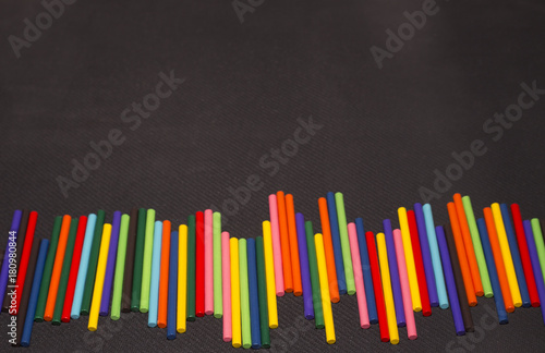 multicolored sticks on a black background