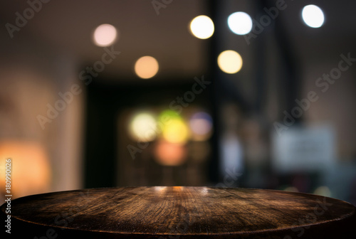 Empty wooden table and blurred background of abstract in front of restaurant or coffee shop for display of product or for montage © Freedomz