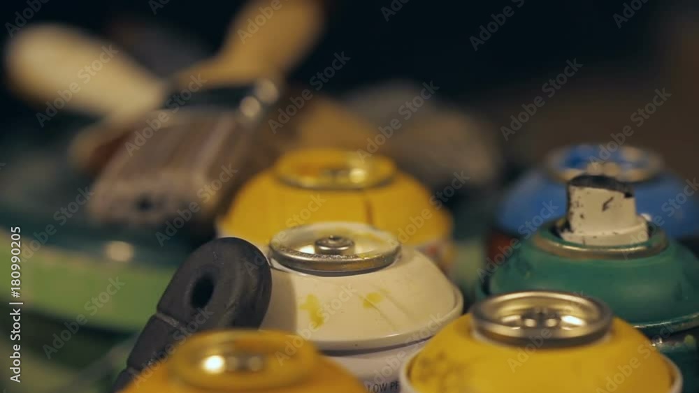 Closeup refocusing Shot from cans with paint to brushes in the Artist's Studio Closeup refocusing Shot from cans with paint to brushes in the Artist's Studio