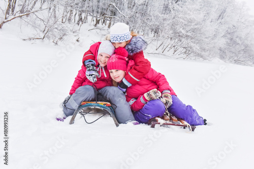 girls enjoying day playing in winter forest