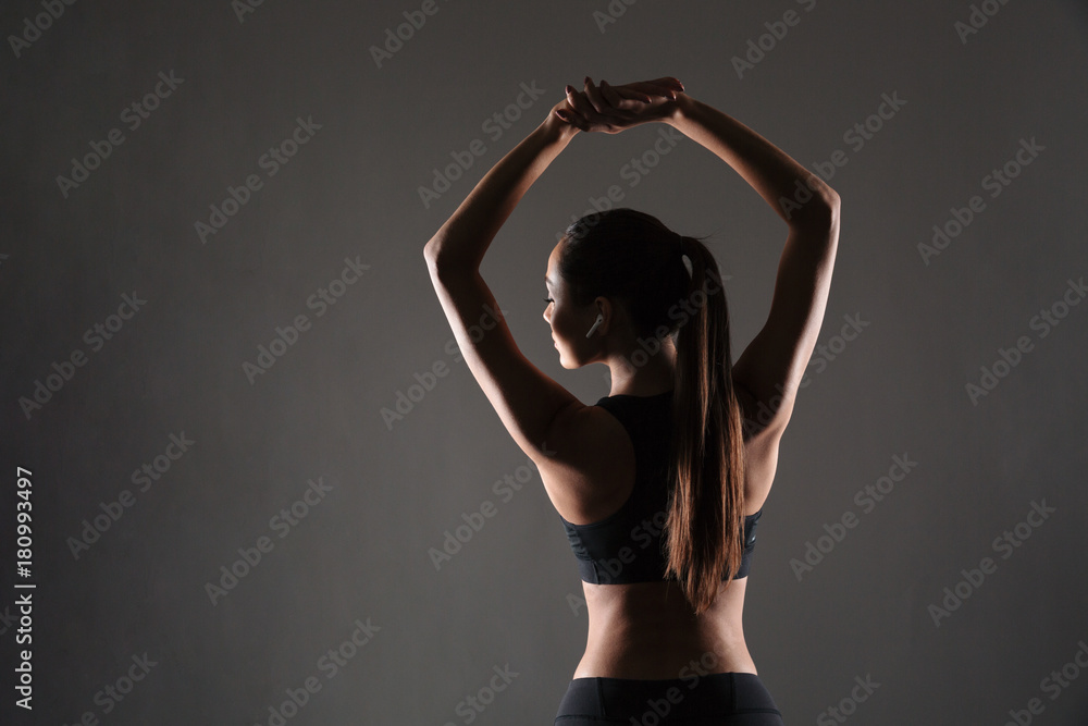 Fototapeta premium Back view portrait of a fit young girl