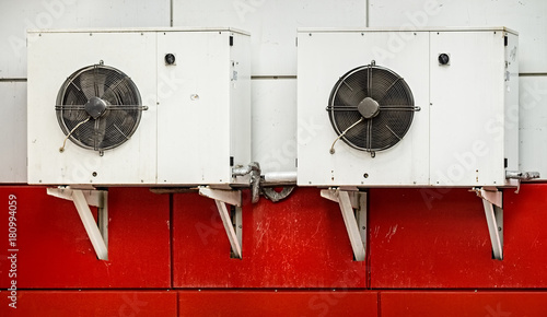 Industrial air conditioners system on side of a building.