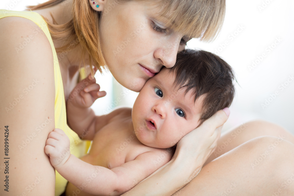 Happy mother with baby at home. Family, child and parenthood concept. Happy mother with baby at home. Family, child and parenthood concept.