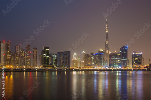 DUBAI  UAE - MARCH 23  2017  The evening panorama over the new Canal with the Downtown and Burj Khalifa tower.