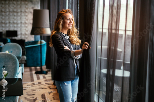 Glamorous woman staring through window