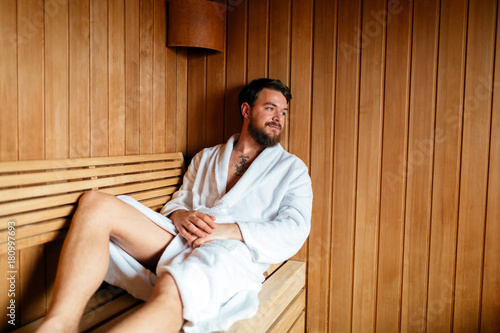 Handsome man relaxing in sauna